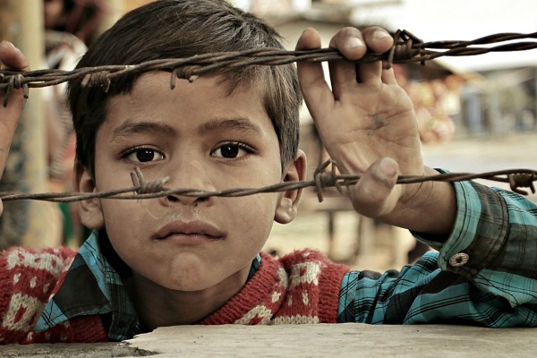 boy behind fence