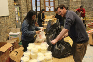 JRS aid workers distribute food kits to struggling families. 