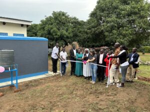 Christina Zetlmeisl, JRS Country director, cuts ribbon to open facilities 