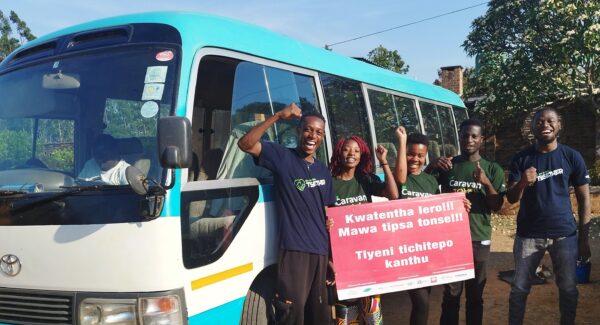 youth climate activists pose with sign demanding climate action, Malawi