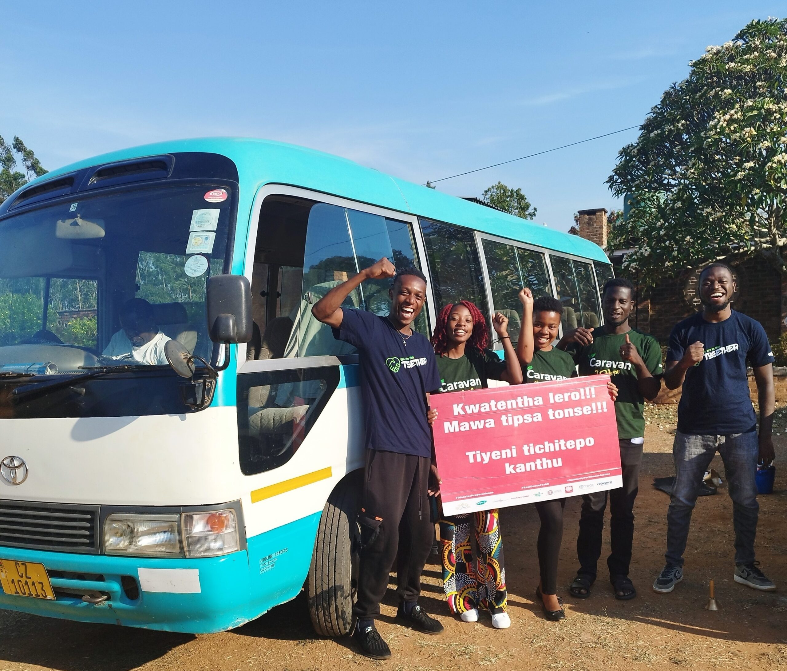 youth climate activists pose with sign demanding climate action, Malawi