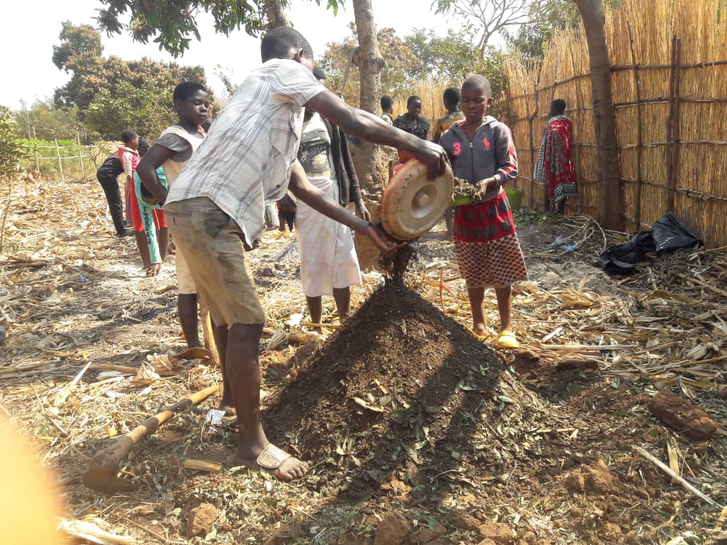 children working farm with organic manure