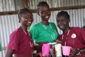 LLS students smile to camera during school meal