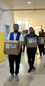 aid workers carry food aid and hygiene kits for displaced. 