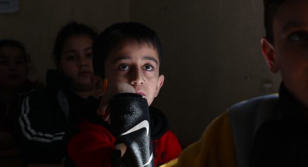 Boy in Beirut, looks to camera in JRS Lebanon migrant centre.